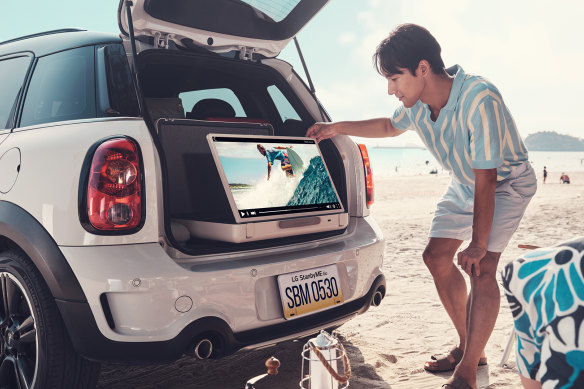 Just drive your car right onto the beach to watch some surfing videos from your boot.