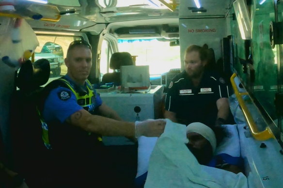 The man, bottom right, suspected of abducting Cleo Smith in an ambulance on Wednesday. 