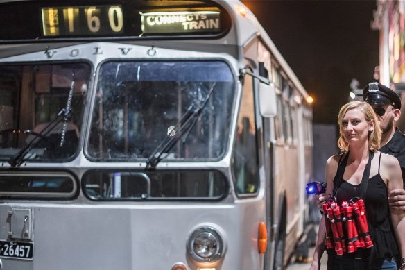 Audience members take their seats on a vintage bus to witness this adaptation of a 1990s action film.