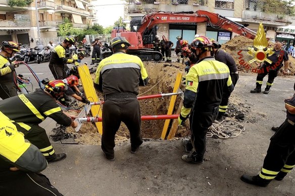 Italian Firefighters dig up the road to rescue a man blocked in a tunnel in Rome. The opening to the tunnel was inside a recently rented store on the street, with its front windows covered in opaque plastic, authorities said. 