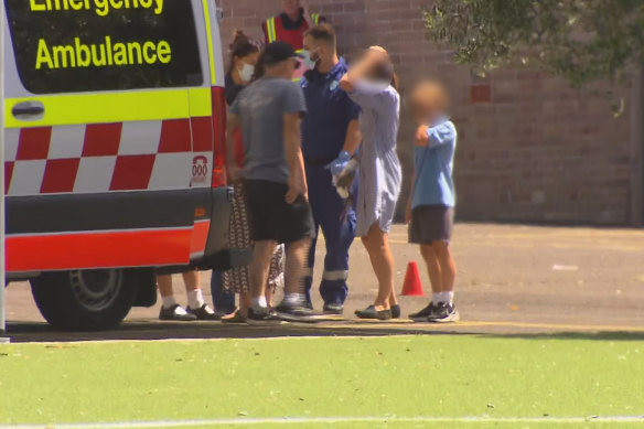 Students at Manly West Public School gather outside the school after the explosion.