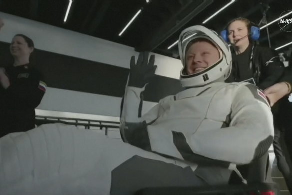 The NASA astronauts exit the SpaceX capsule.