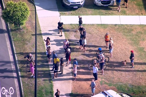 Onlookers watch as firefighters battle the blaze.