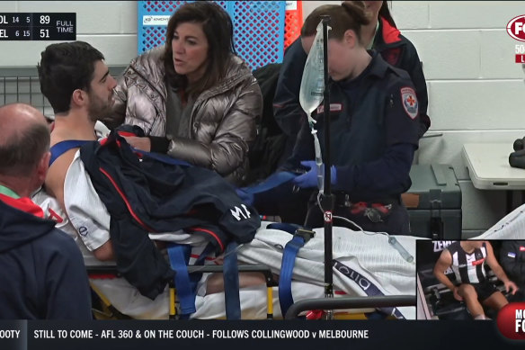 Christian Petracca is comforted by his mother Elvira after he was injured in the game against Collingwood.