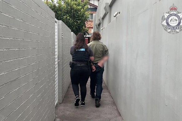 Cameron Spring being led out of his Canterbury home after being arrested last week.