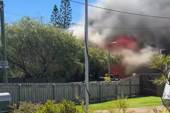 Three people have been assessed by paramedics outside a house fire in Redland Bay.