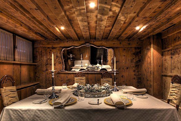 Wood-panelled dining room at La Stüa de Michil, a Michelin-starred restaurant in the heart of the Italian Dolomites.