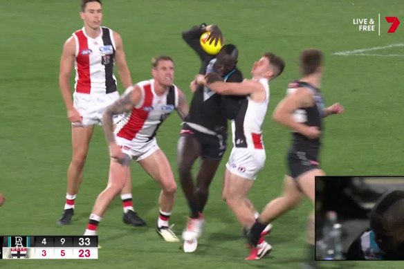 Jack Higgins tackles Port Adelaide’s Aliir Aliir.
