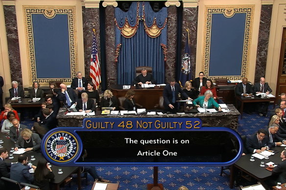 In this image from video, the vote total, 52-48 for not guilty, on the first article of impeachment, abuse of power, is displayed on screen during the impeachment trial against President Donald Trump in the Senate.