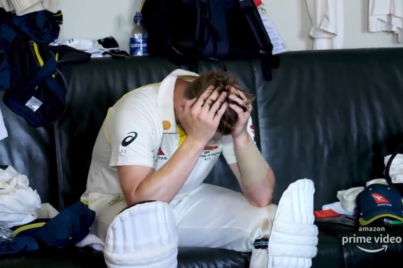 An inconsolable Steve Smith sitting with his head in his hands after being dismissed at a key moment in the game.