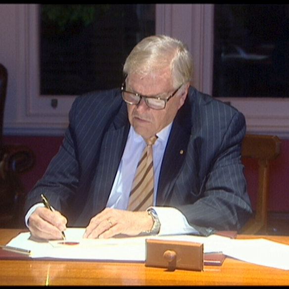 WA Governor Kim Beazley signing the anti-Clive Palmer legislation into law.