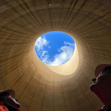 The ultimate echo chamber: Greenspot chief executive Brett Hawkins (left) and part owner Neil Schembri look skyward from inside the cooling tower of the shuttered Wallerawang Power Station. 