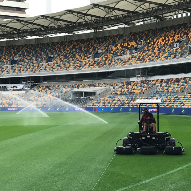 Cutting the AFL-specific grid into the Gabba turf.