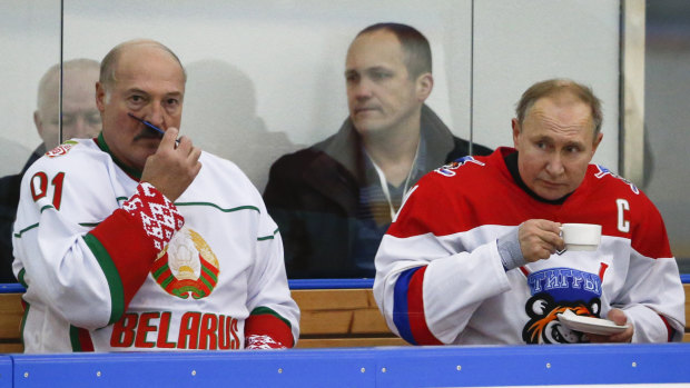 Belarusian President Alexander Lukashenko, left, and Russian President Vladimir Putin, take a break during a hockey game in Sochi, Russia. 