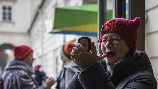 Susanne Scholl applies make-up before the demonstration against racism in Vienna last month.