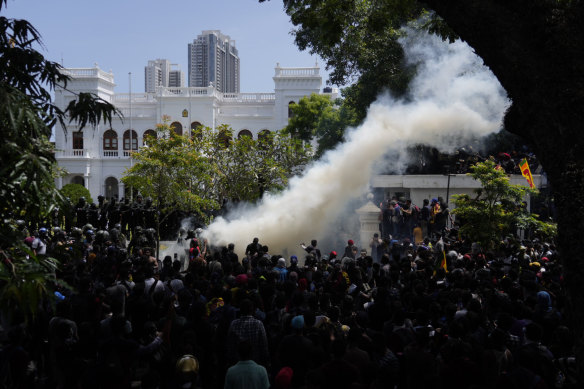 Police use teargas as Sri Lankan protesters storm the compound of prime minister Ranil Wickremesinghe’s office, demanding he resign after president Gotabaya Rajapaksa fled amid economic crisis in Colombo, Sri Lanka, on Wednesday.