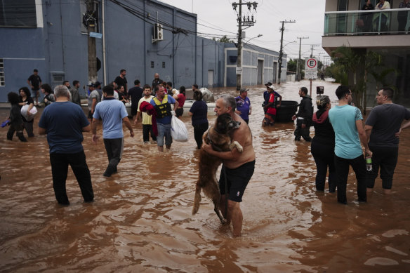Residents evacuate from a neighbourhood flooded by heavy rains, in Canoas, Brazil.