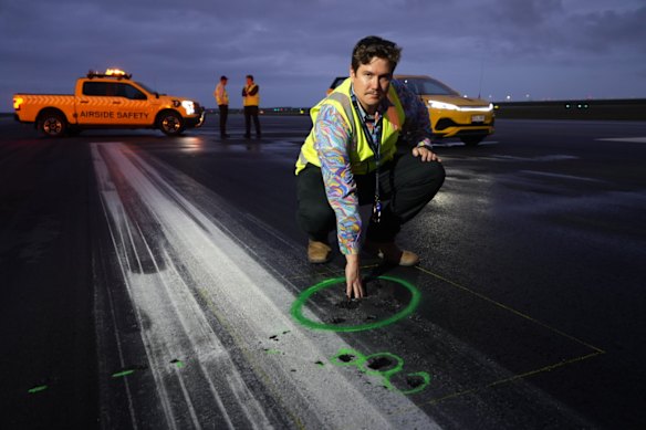 Brisbane Airport senior asset civil engineer Fraser Stevens surveying the impact of the lightning strike. 