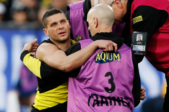 Dion Prestia is helped to his feet after the heavy knock.