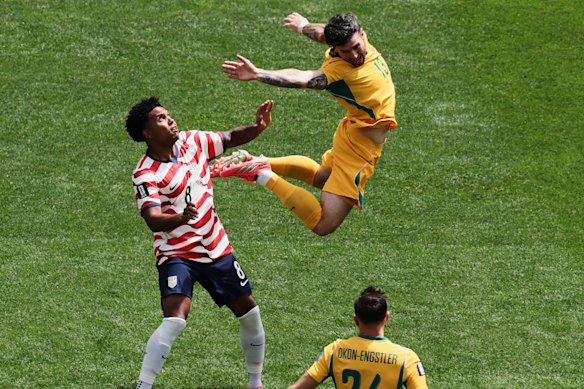 USA's Weston McKennie and Australia's Aiden O'Neill fight for the ball.