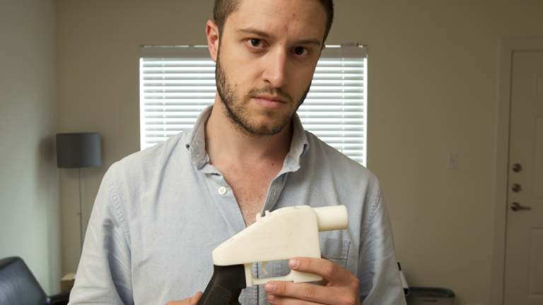 Cody Wilson, the founder of Defense Distributed, shows a plastic handgun made on a 3D-printer at his home in Austin, Texas. 