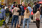 People searching for relatives who were traveling on the trains involved in a collision gather at a religious residence converted into a temporary medical facility in Toledo.