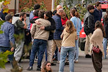 People searching for relatives who were traveling on the trains involved in a collision gather at a religious residence converted into a temporary medical facility in Toledo.