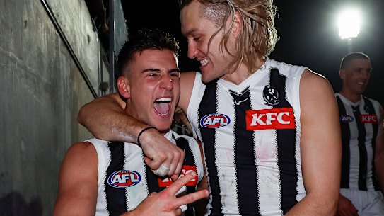 Nick Daicos of the Magpies (left) and Darcy Moore of the Magpies celebrate.