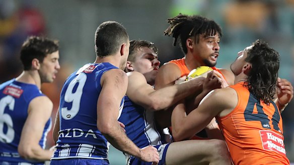 Connor Idun of the Giants is wrapped up by Cameron Zurhaar.