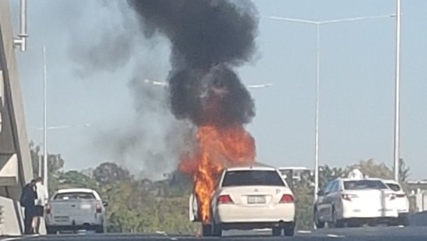A car caught on fire follow a two-car crash on the Inner City Bypass.