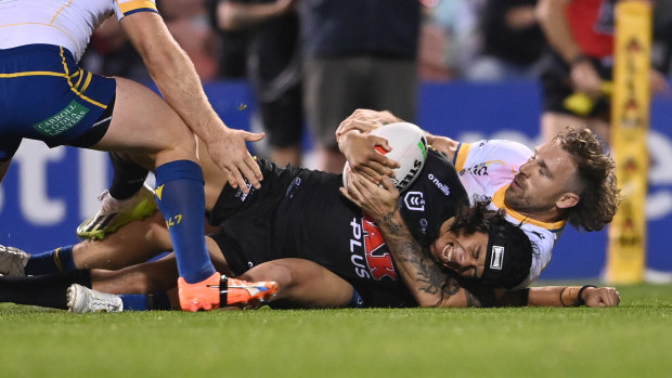 Jarome Luai grimaces in pain as he dislocates his shoulder against the Eels in round 26.