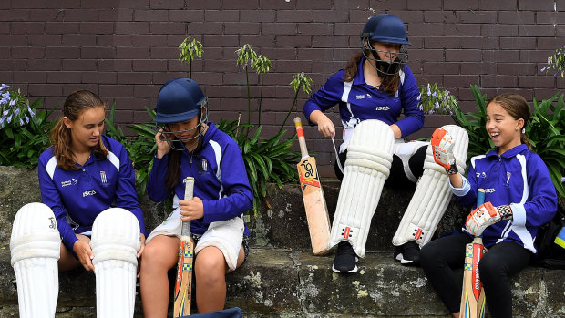 Marrickville Hudson under 15 girls cricket team players Siobhan O’Donnell 13 (left), Kira Hodgson-Yu 13 (2nd from left), Grace Keating 13 (2nd from right) and April Humphrys 12 (right) put on cricket helmets and lads before doing some catching drills at Petersham Oval.