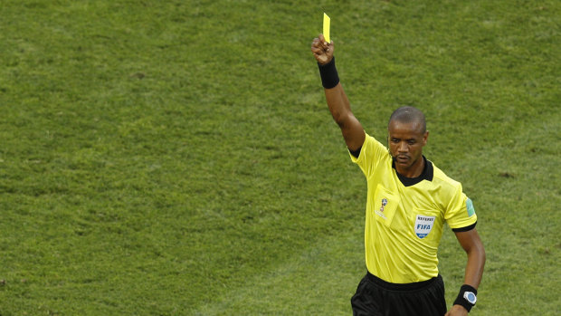 Zambian referee Janny Sikazwe shows a yellow card during the group G match between Belgium and Panama at this year's World Cup in Russia.