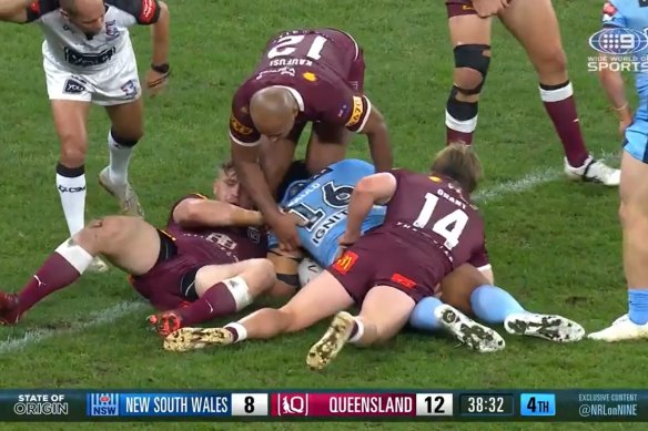 Felise Kaufusi squeezes Junior Paulo’s head between his legs as Harry Grant lies on the NSW prop.