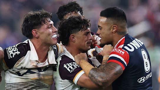 Spencer Leniu (right) of the Roosters exchanges heated words with Kotoni Staggs of the Broncos in Las Vegas.