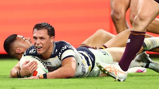 Scott Drinkwater of the Cowboys scores a try against the Broncos.