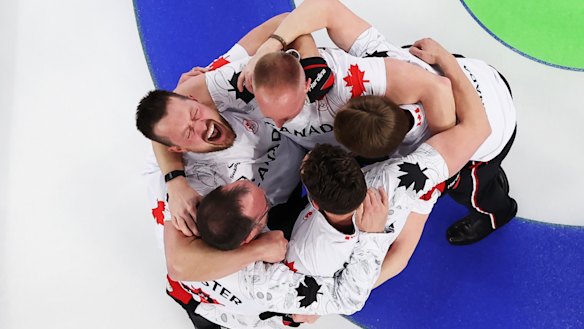 Curling gold medallists Brad Jacobs, Marc Kennedy, Brett Gallant and Ben Hebert, of Team Canada, celebrate victory with coach Paul Webster.