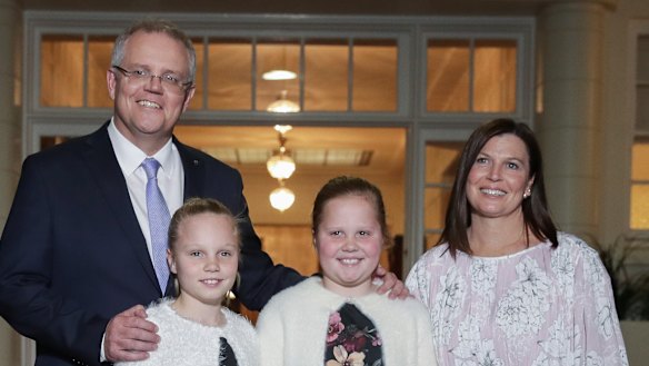 Prime Minister Scott Morrison with his wife Jenny and daughters Abigail and Lily pose for photos after being sworn-in at Government House in Canberra on Friday.