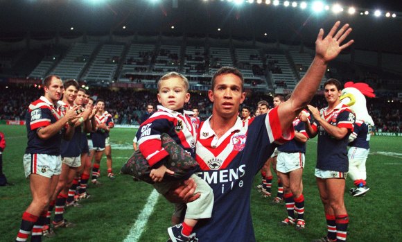 Boy, you've come a long way: Lachlan Lam joins his famous dad on the field for Adrian's last home game for the Roosters in 2000.