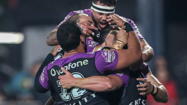 Group hug: Blake Green is mobbed by teammates after his second-half try sealed the win for the Warriors.