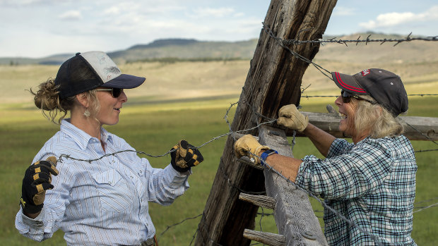 Caitlyn Taussig and her mother, Vicki, mend fences on their ranch in Kremmling.