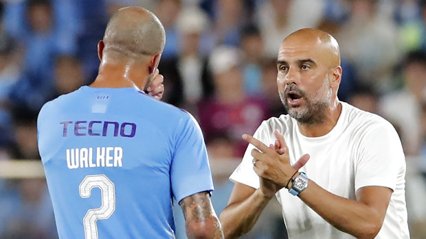 Tight race this year: Manchester City's manager Pep Guardiola, right, gestures to Kyle Walker.