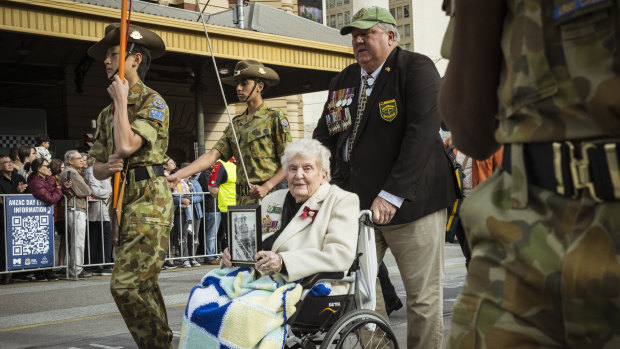 Betty Quee, 87, took part in the march while carrying a photo of her late husband, Brian Quee. Her son James Quee (pictured) attended the ceremony with her.