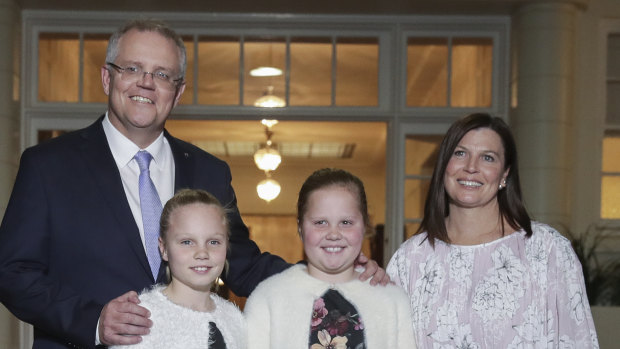 Prime Minister Scott Morrison with his wife Jenny and daughters Abigail and Lily pose for photos after being sworn-in at Government House in Canberra on Friday.