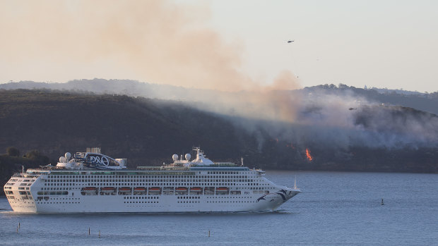 Visitors on a cruise ship catch a glimpse of burning bush at Dobroyd Point. 