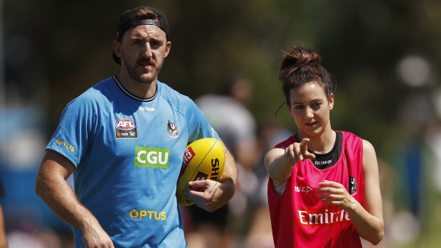 Collingwood defender Lynden Dunn, also an AFLW assistant coach, with  AFLW Magpies skipper Stephanie Chiocci on Wednesday.