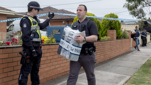 Forensic police remove evidence from the Campbellfield home.