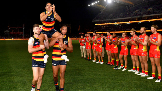 Carried away: Eddie Betts is shouldered off the field through a line of honour.