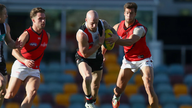 Run and carry: St Kilda's Zak Jones charges through an attempted tackle.