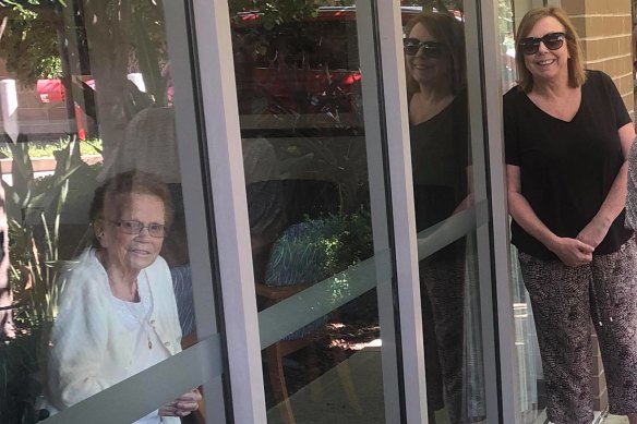 Mary Watson, right, visited her mother, Alice Bacon, at Newmarch House through the window for her birthday on April 5.